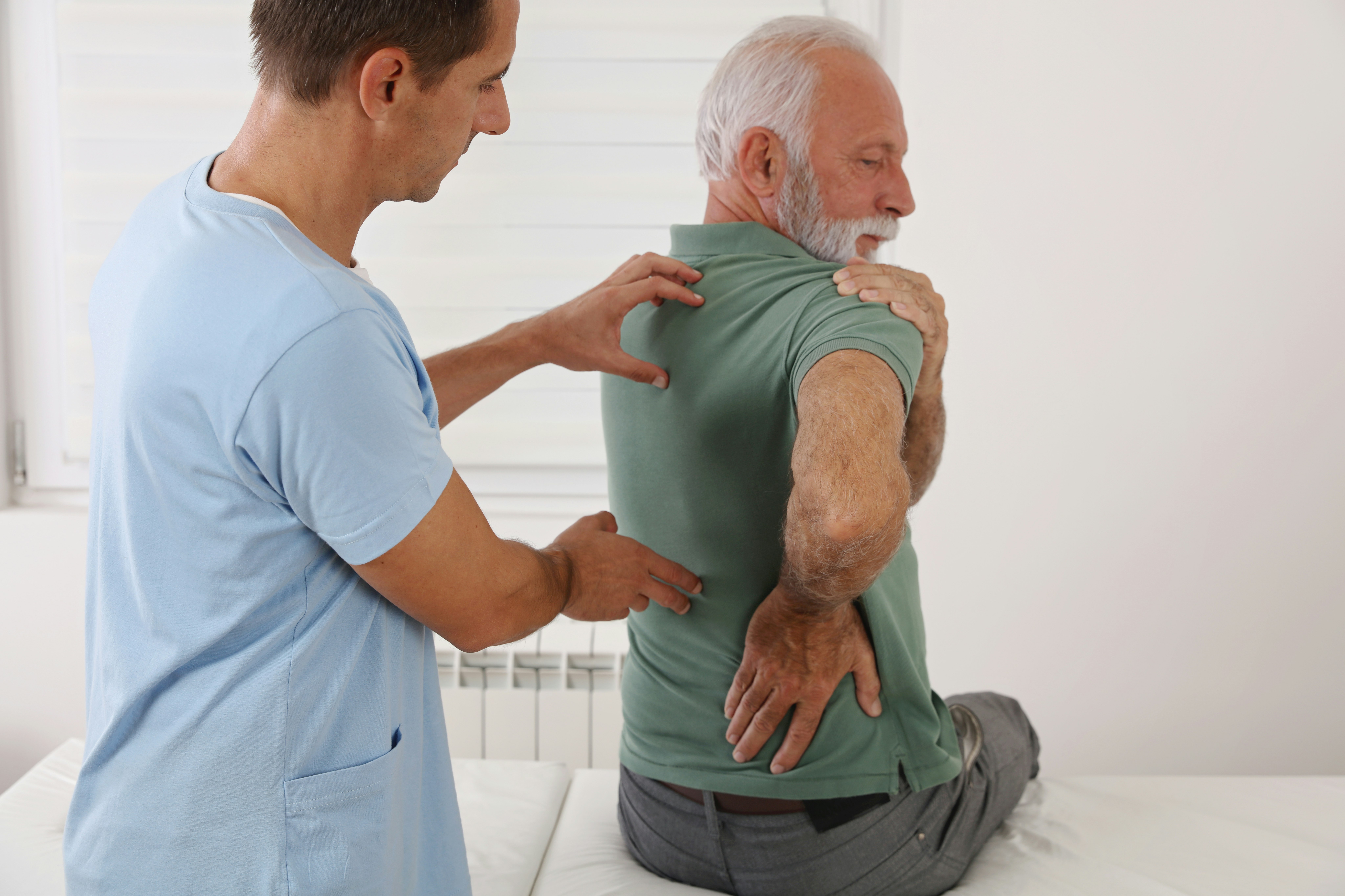 Senior man with back pain. Spine physical therapis