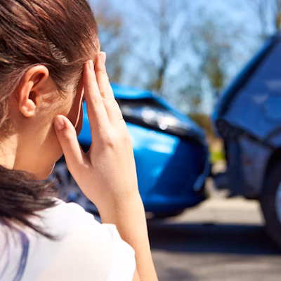 Concerned driver with defocused traffic accident