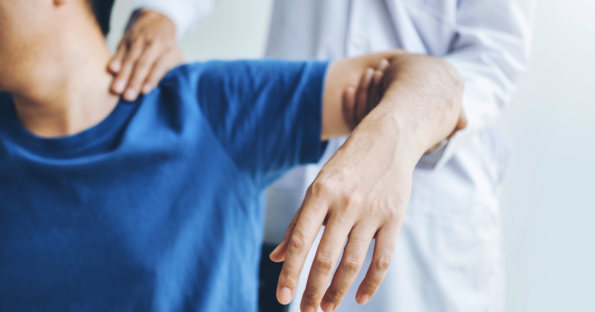 Doctor consulting with patient about shoulder pain