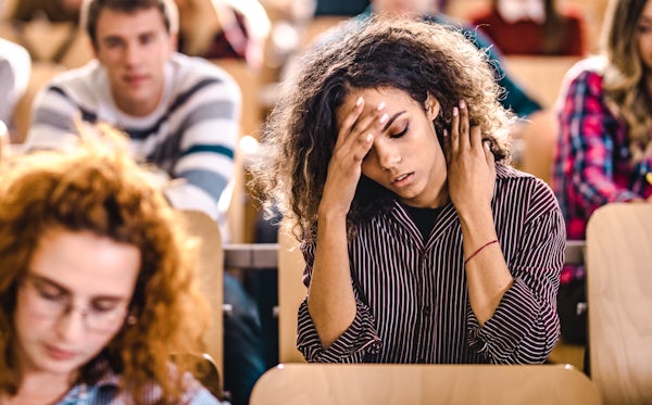 Young university student having a headache on a cl